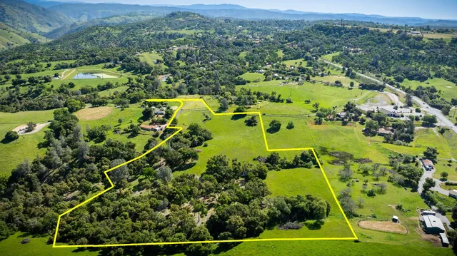 a view of a lush green hillside and an houses