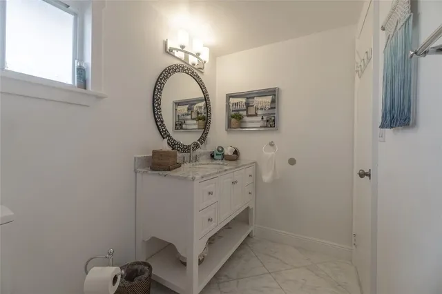 a bathroom with a mirror and a sink