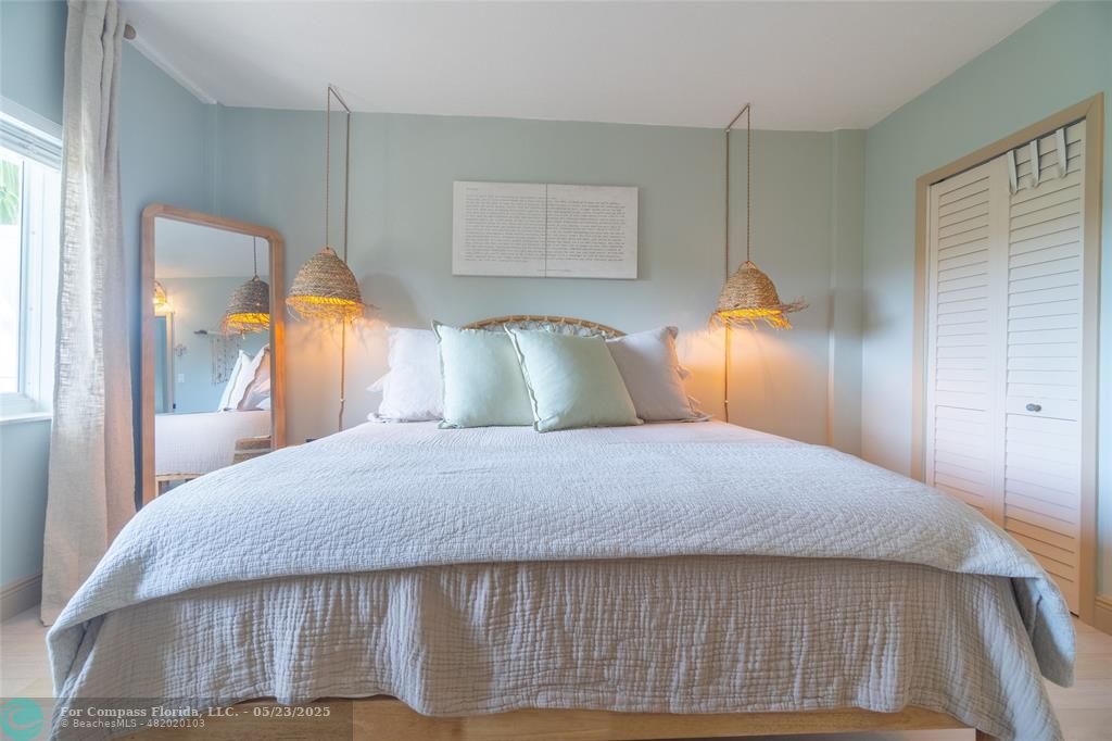 6520 North Ocean Boulevard, Unit 22 Boynton Beach, FL 33435 - Photo 15 of 27 a bedroom with a bed and wooden floor