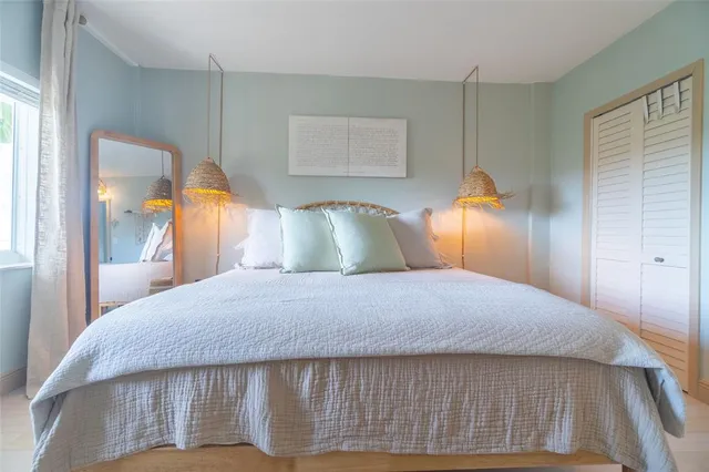 a bedroom with a bed and lamp