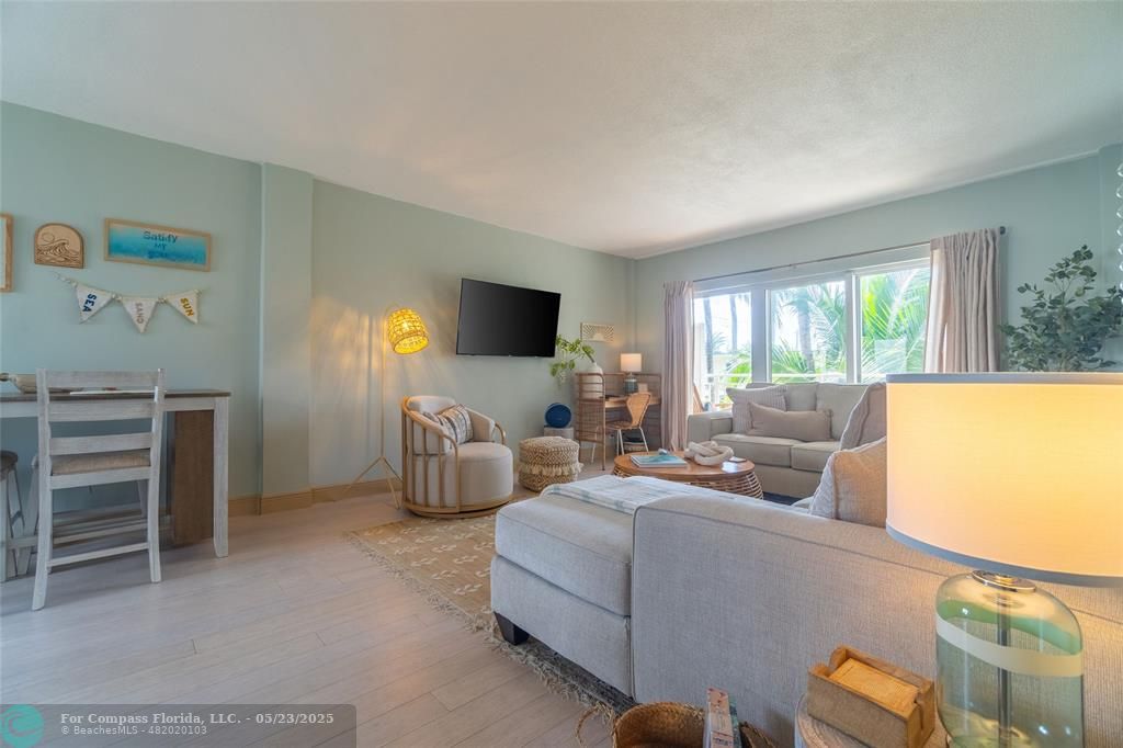 6520 North Ocean Boulevard, Unit 22 Boynton Beach, FL 33435 - Photo 19 of 27 a living room with furniture and a flat screen tv