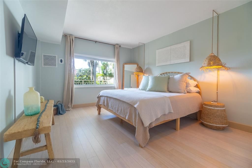 6520 North Ocean Boulevard, Unit 22 Boynton Beach, FL 33435 - Photo 3 of 27 a bedroom with a bed chair and window