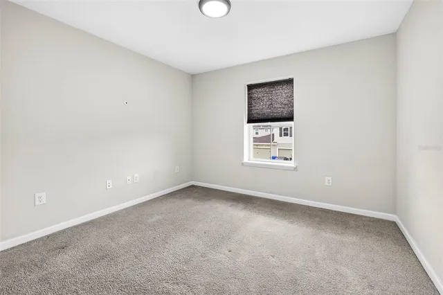 a bathroom with a granite countertop sink a toilet and a mirror