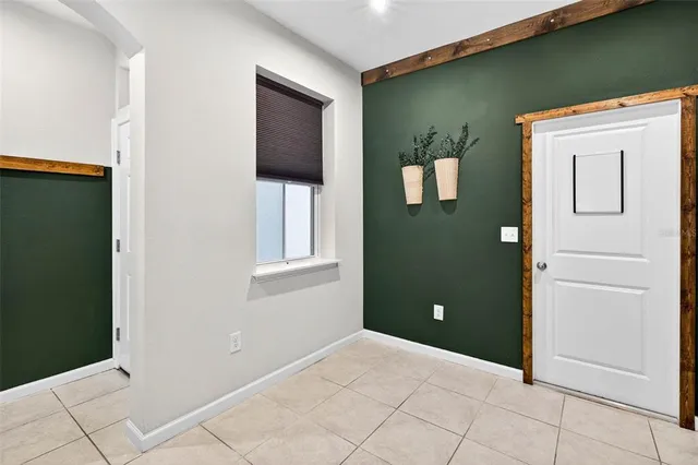 a view of a hallway with wooden cabinets and a window