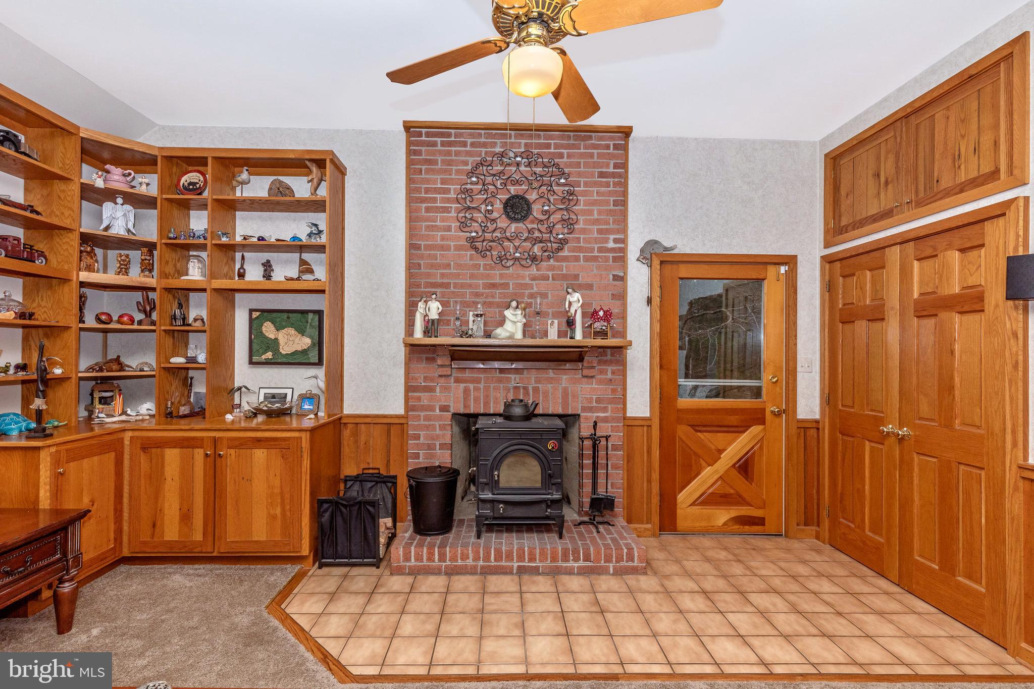 11789 Rowe Road Monrovia, MD 21770 - Photo 21 of 82 Family Room with Wooden Stove in Brick Fireplace