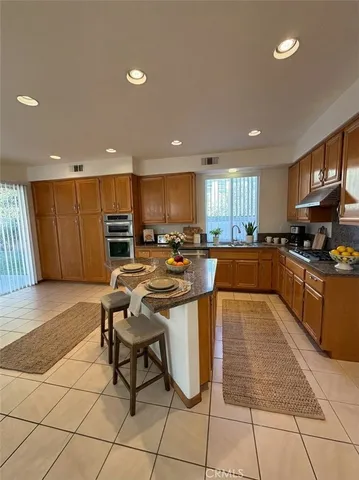 a kitchen with stainless steel appliances lots of counter top space cabinets and a sink