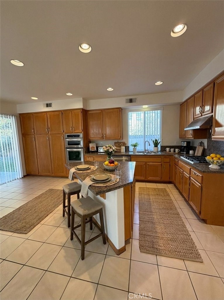 a kitchen with stainless steel appliances lots of counter top space cabinets and a sink