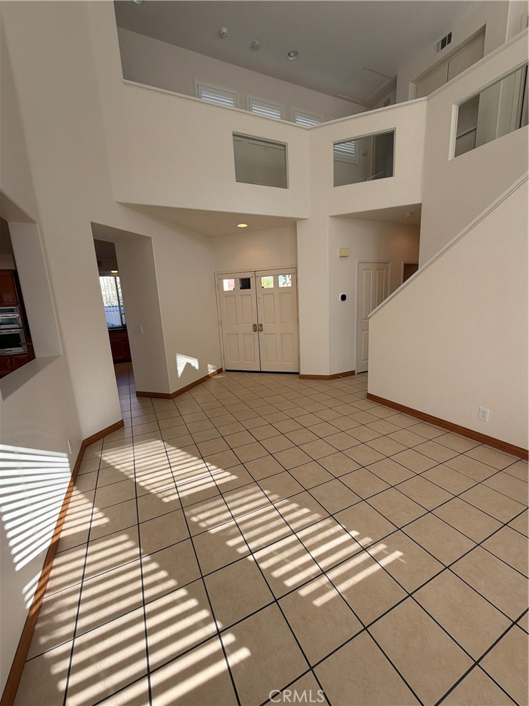 17 Pastora Lake Forest, CA 92610 - Photo 15 of 53 a view of a bedroom with a large bed and a chandelier