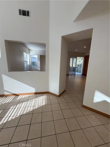 a large kitchen with a large counter top and stainless steel appliances