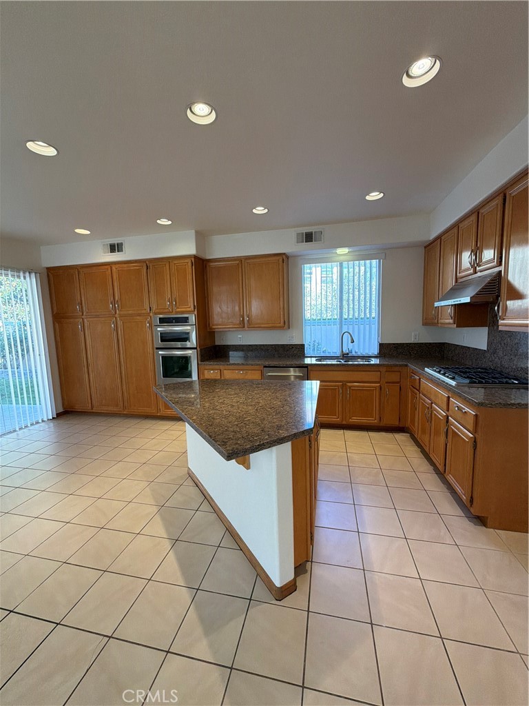 17 Pastora Lake Forest, CA 92610 - Photo 24 of 53 a large kitchen with a large counter top and stainless steel appliances