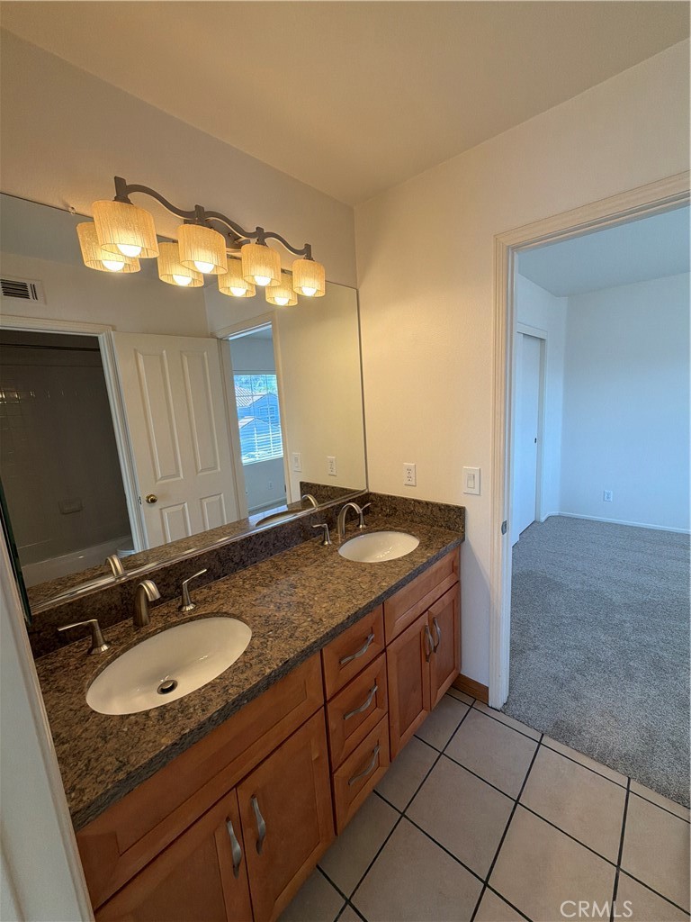 17 Pastora Lake Forest, CA 92610 - Photo 31 of 53 a bathroom with a granite countertop sink and a mirror