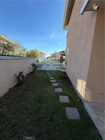 a view of a patio with chairs and plants