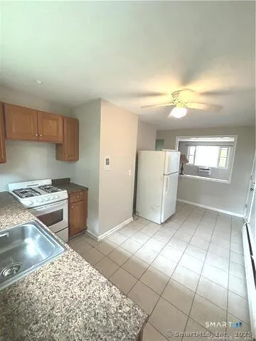 a kitchen with a sink a stove and cabinets