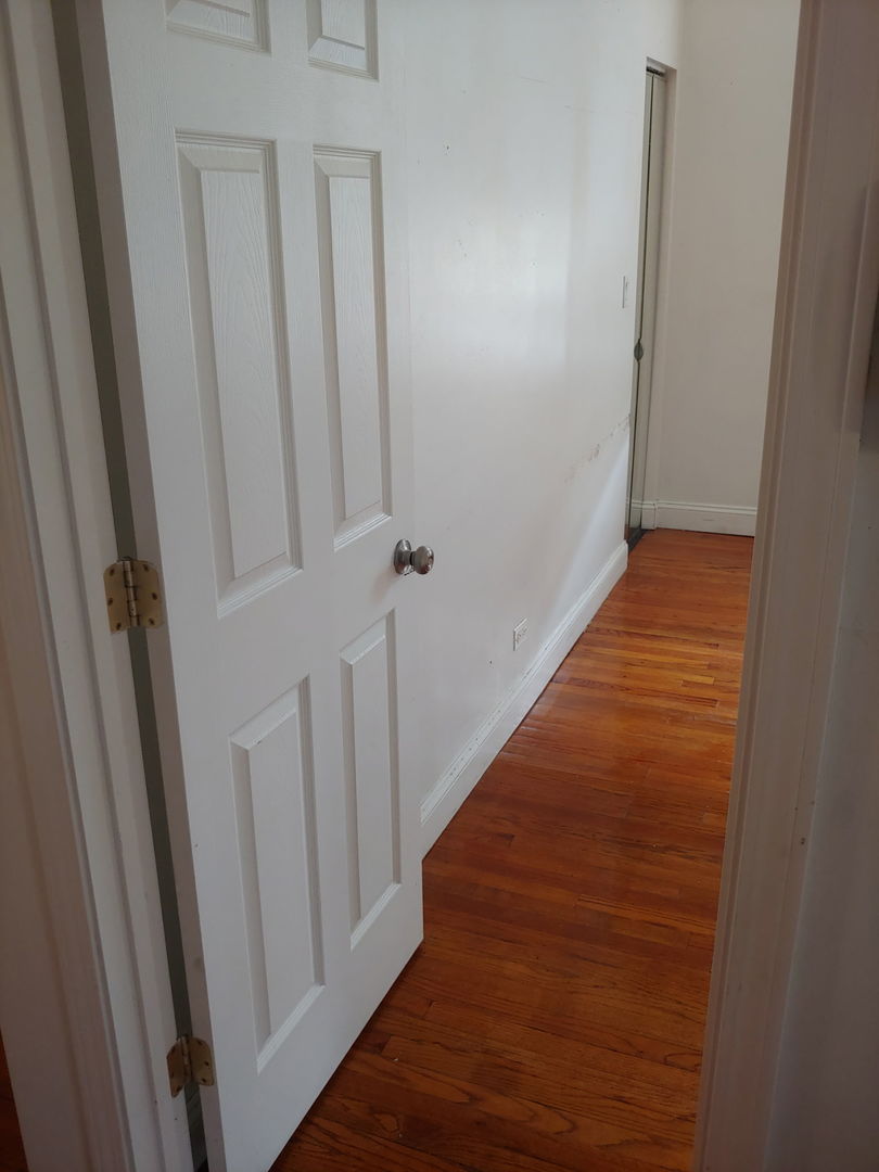 307 East 50th Street, Unit 307A Chicago, IL 60615 - Photo 5 of 10 a view of a hallway with wooden floor