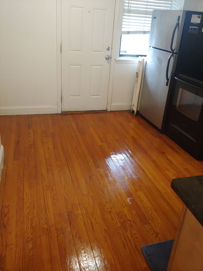 307 East 50th Street, Unit 307A Chicago, IL 60615 - Photo 8 of 10 a view of an empty room with wooden floor and a window