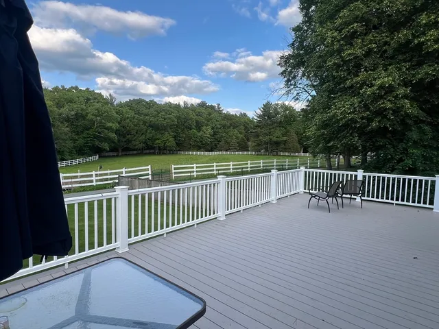 a balcony with wooden floor and fence