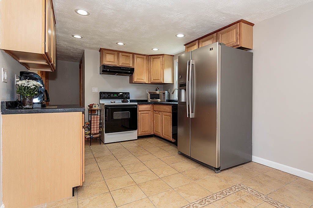 9 Arbor Road Chelmsford, MA 01863 - Photo 16 of 25 a kitchen with stainless steel appliances granite countertop a refrigerator sink and cabinets