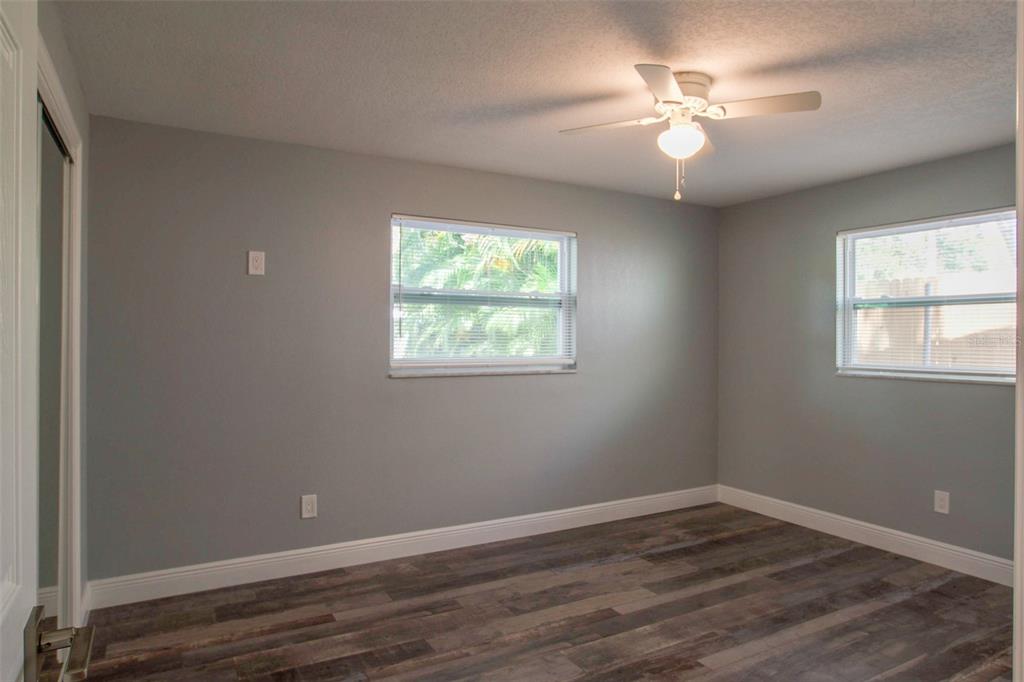 715 Bay Street Dunedin, FL 34698 - Photo 14 of 19 a view of an empty room with wooden floor and a window