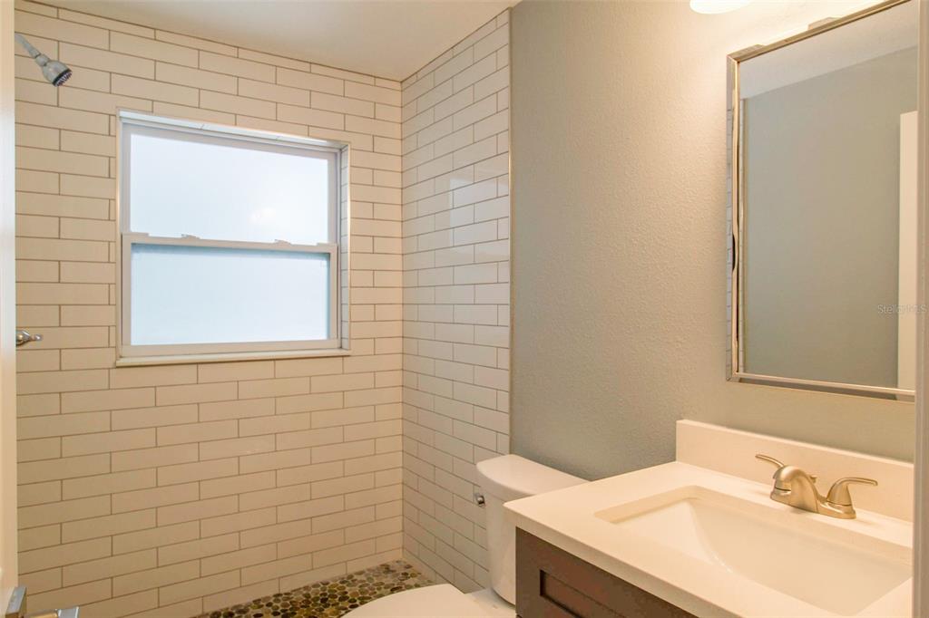 715 Bay Street Dunedin, FL 34698 - Photo 17 of 19 a bathroom with a sink and a toilet