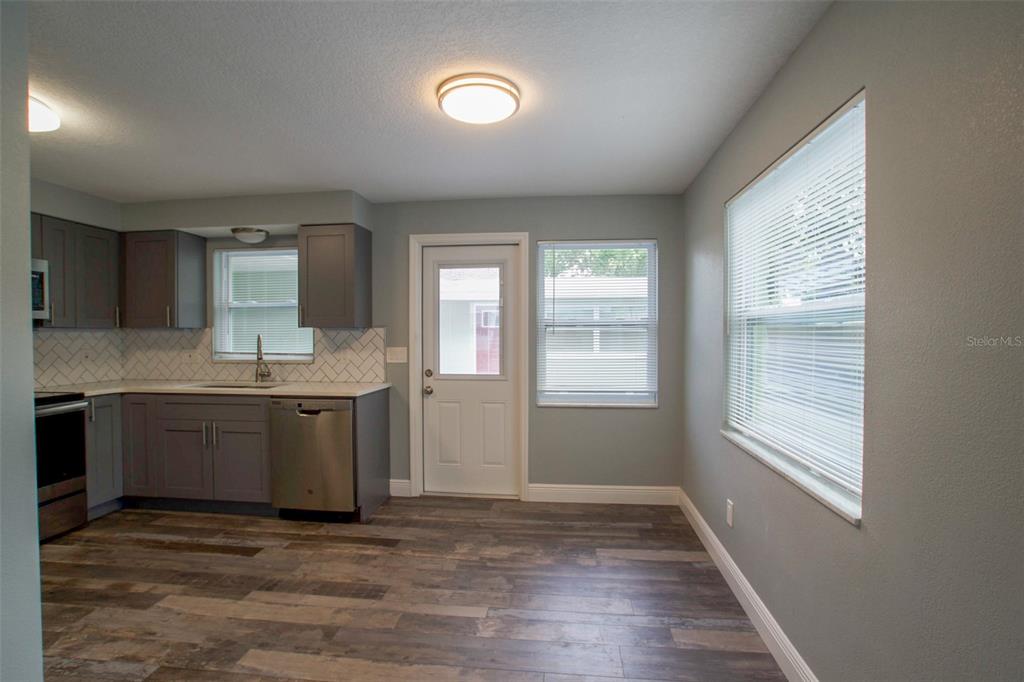 715 Bay Street Dunedin, FL 34698 - Photo 7 of 19 a view of an empty room with window and wooden floor