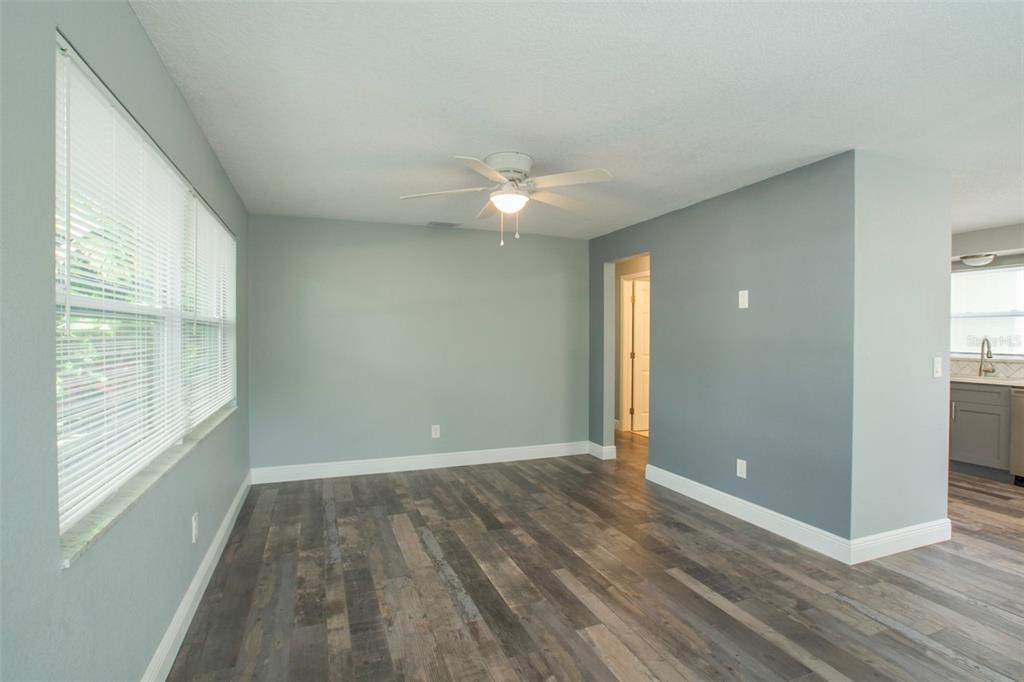 715 Bay Street Dunedin, FL 34698 - Photo 9 of 19 an empty room with wooden floor and windows