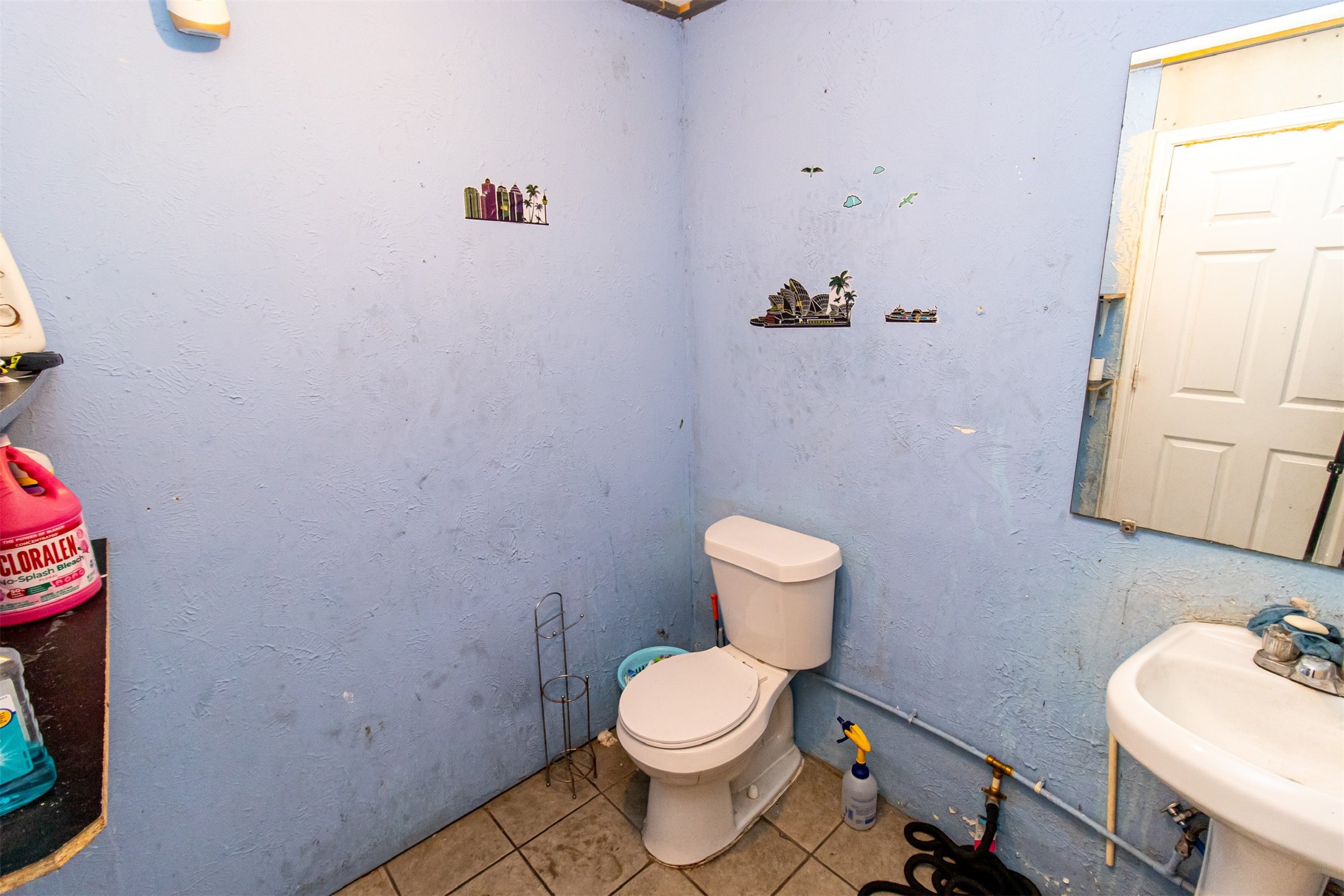 1137 Freeport Street Houston, TX 77015 - Photo 25 of 27 a white toilet sitting next to a bathroom sink