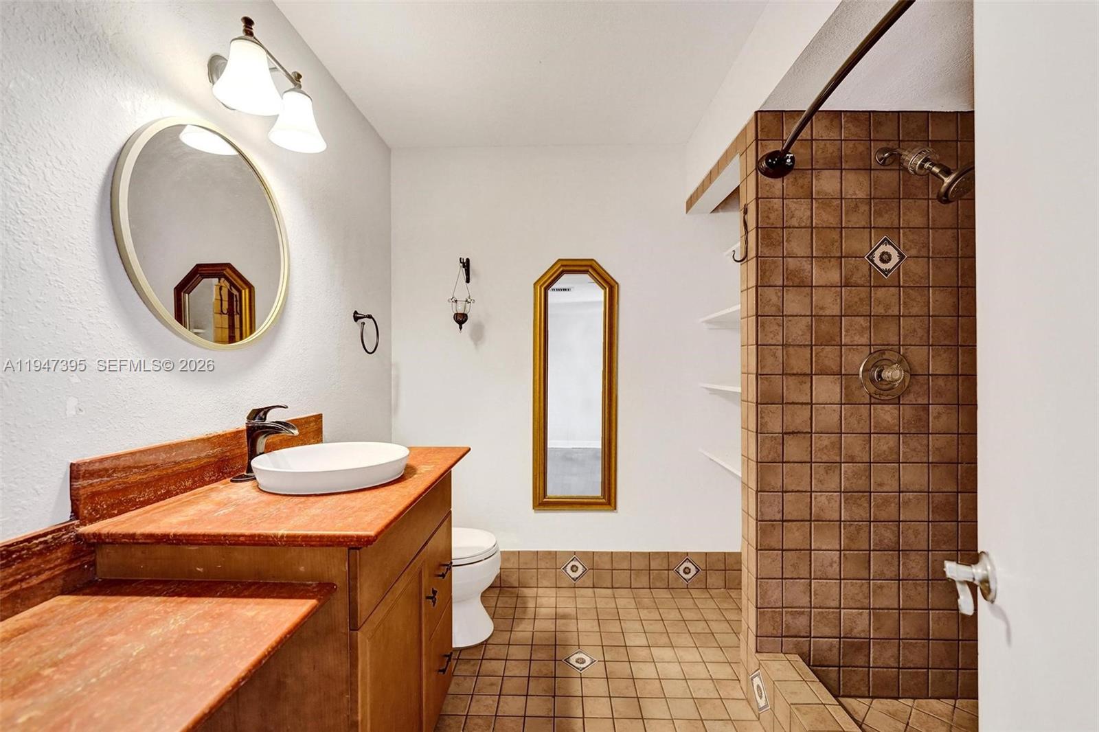 2990 Oaktree Lane, Unit 338 Hollywood, FL 33021 - Photo 14 of 24 a bathroom with a sink and a mirror