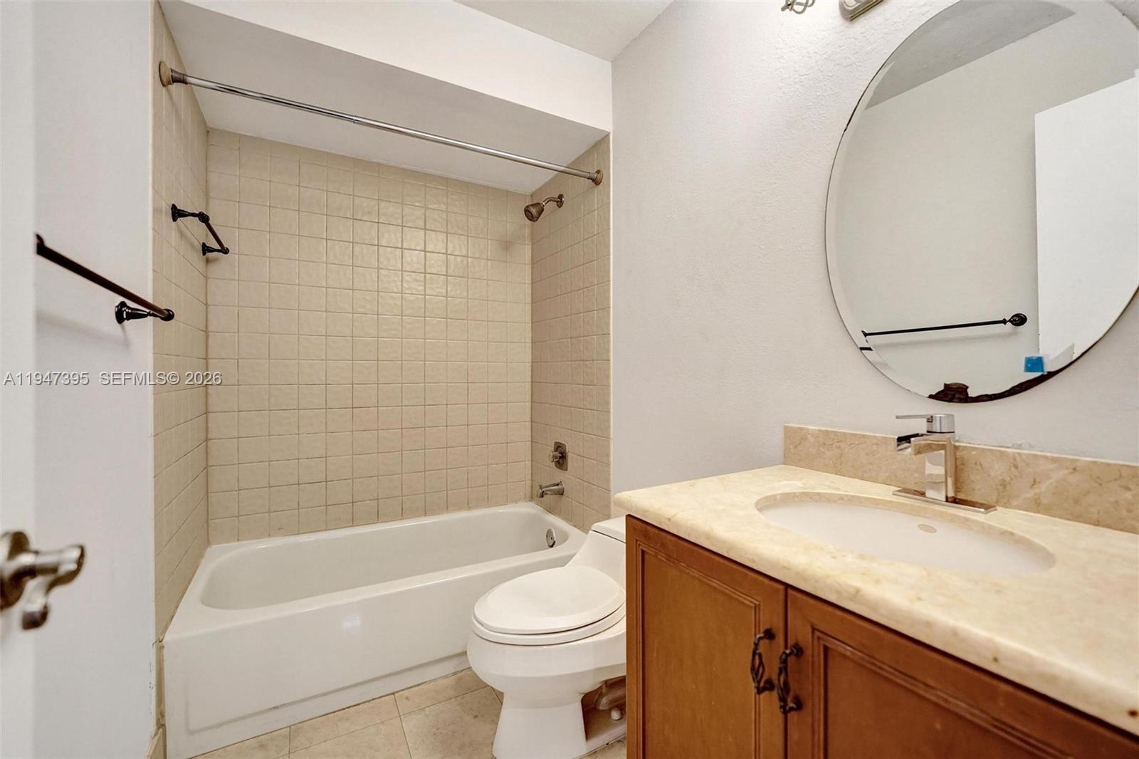2990 Oaktree Lane, Unit 338 Hollywood, FL 33021 - Photo 17 of 24 a bathroom with a sink a toilet and a bathtub