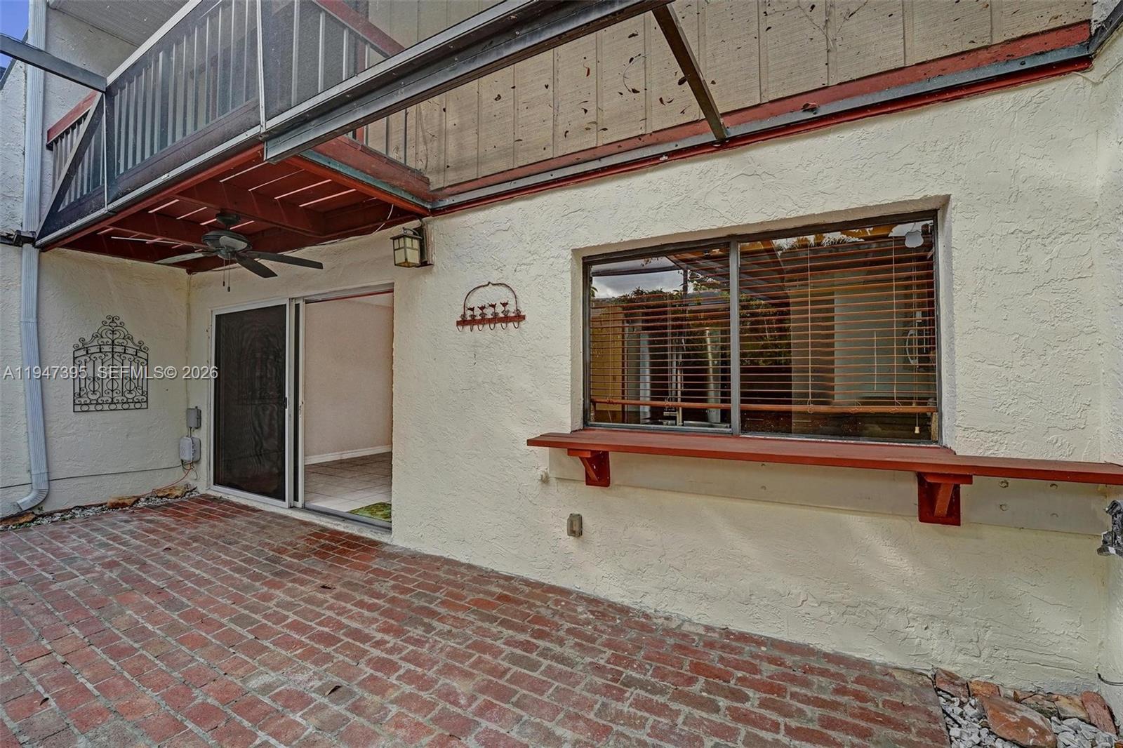 2990 Oaktree Lane, Unit 338 Hollywood, FL 33021 - Photo 19 of 24 a view of a patio with a table and chairs