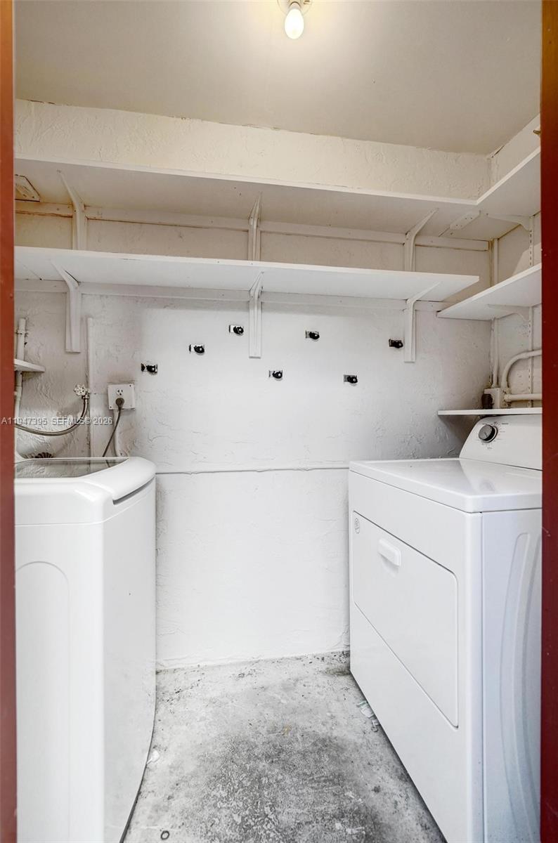 2990 Oaktree Lane, Unit 338 Hollywood, FL 33021 - Photo 22 of 24 a utility room with cabinets washer and dryer