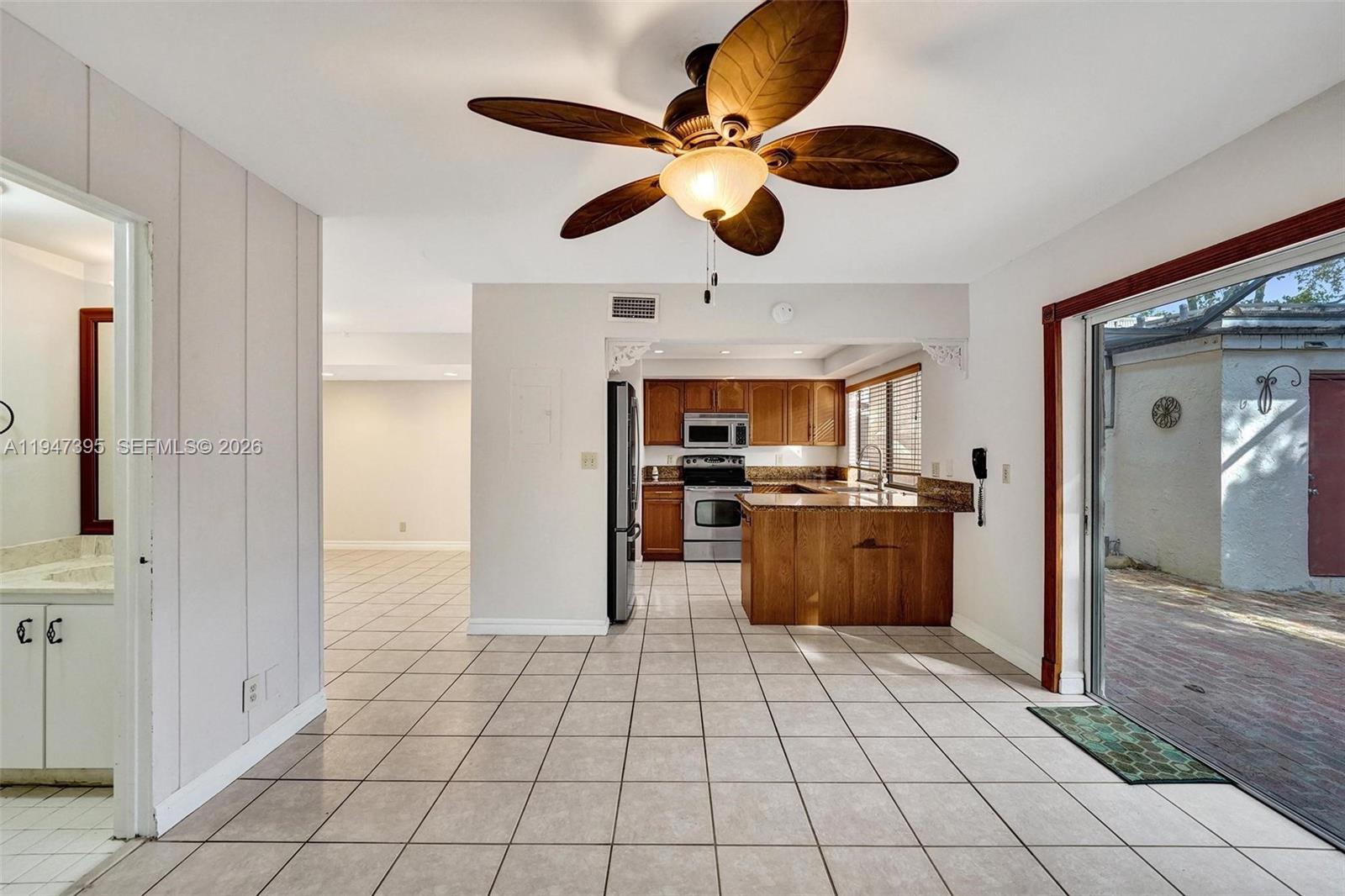 2990 Oaktree Lane, Unit 338 Hollywood, FL 33021 - Photo 9 of 24 a view of a kitchen with kitchen island stainless steel appliances a counter space and cabinets