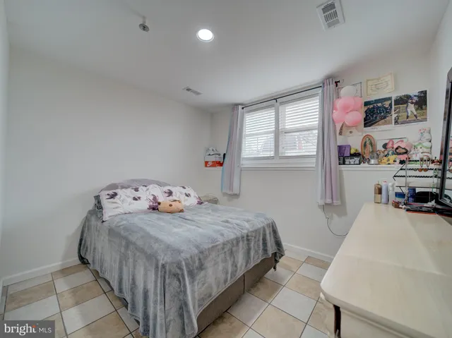 a bedroom with bed and a window