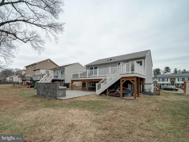 a view of a house with a yard and sitting area