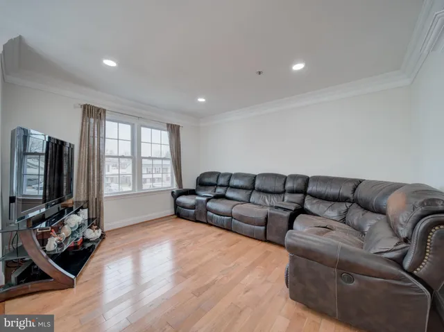 a living room with furniture window and a flat screen tv