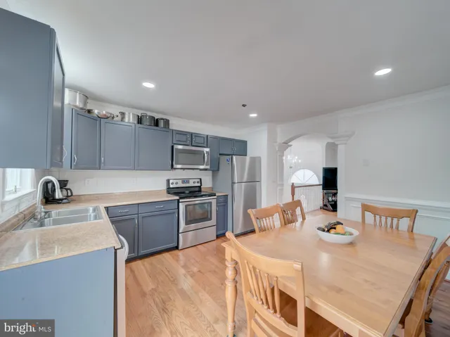 a kitchen with stainless steel appliances kitchen island granite countertop a sink and stove