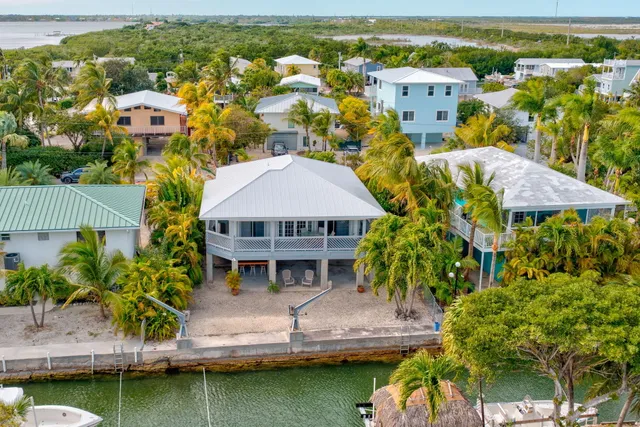 an aerial view of residential houses with yard