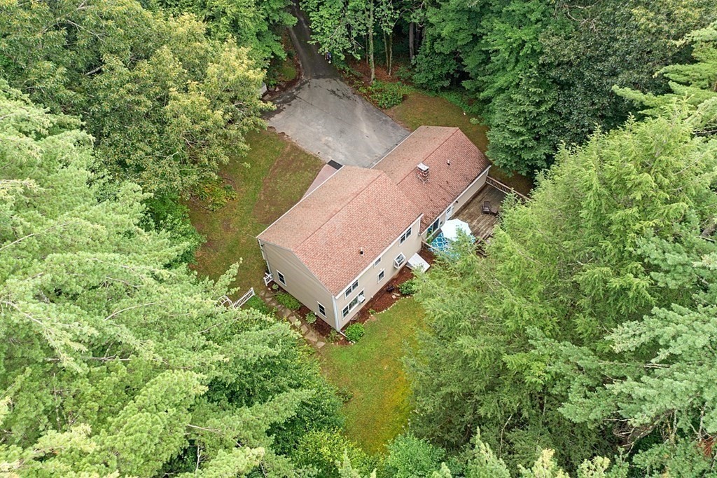 69 Hill Road Groton, MA 01450 - Photo 11 of 42 an aerial view of a house with a yard and trees all around