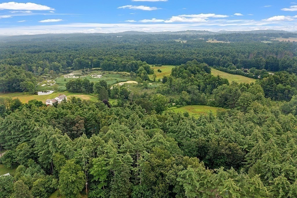 69 Hill Road Groton, MA 01450 - Photo 13 of 42 a view of a green field with lots of green space