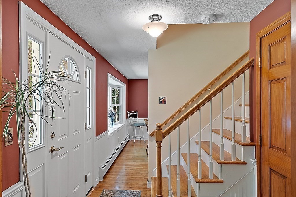 69 Hill Road Groton, MA 01450 - Photo 18 of 42 a view of an entryway with wooden floor
