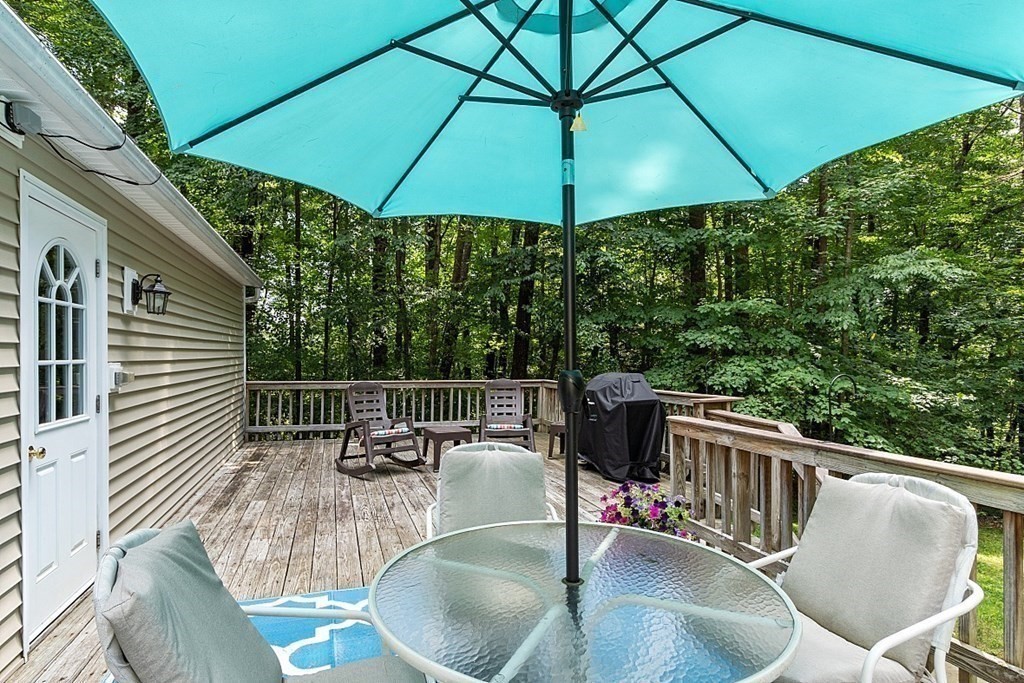 69 Hill Road Groton, MA 01450 - Photo 20 of 42 a balcony with table and chairs