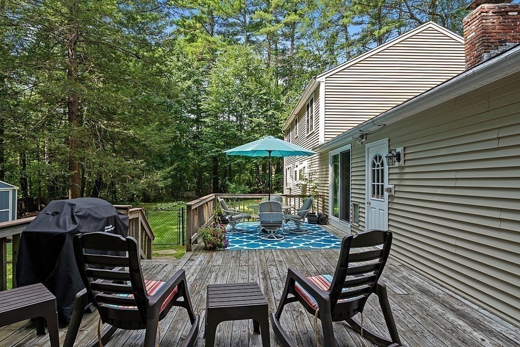 69 Hill Road Groton, MA 01450 - Photo 21 of 42 a backyard of a house with table and chairs