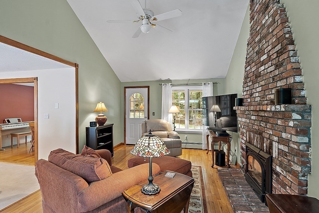 69 Hill Road Groton, MA 01450 - Photo 22 of 42 a living room with furniture and a fireplace