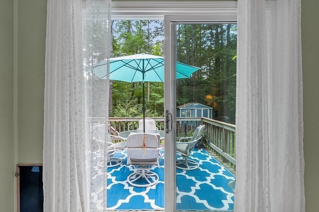 69 Hill Road Groton, MA 01450 - Photo 24 of 42 a balcony view with a floor to ceiling window and yard