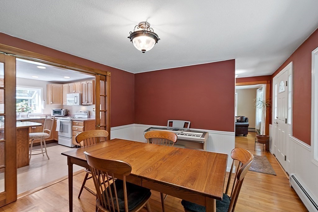 69 Hill Road Groton, MA 01450 - Photo 30 of 42 a view of a dining room with furniture and wooden floor