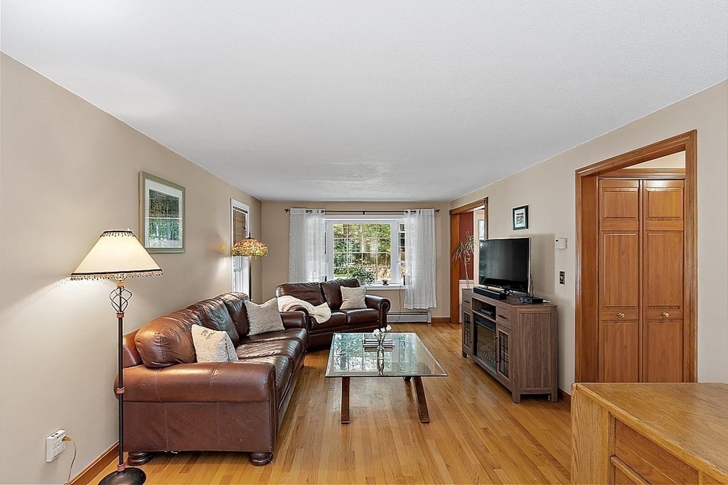69 Hill Road Groton, MA 01450 - Photo 32 of 42 a living room with furniture and a flat screen tv