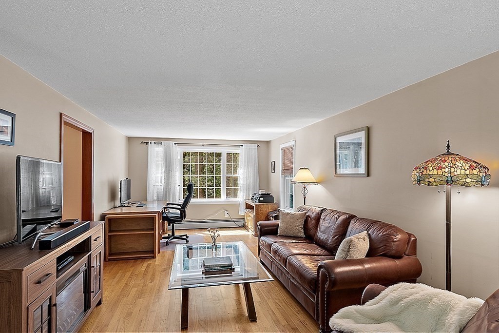69 Hill Road Groton, MA 01450 - Photo 33 of 42 a living room with furniture and a flat screen tv