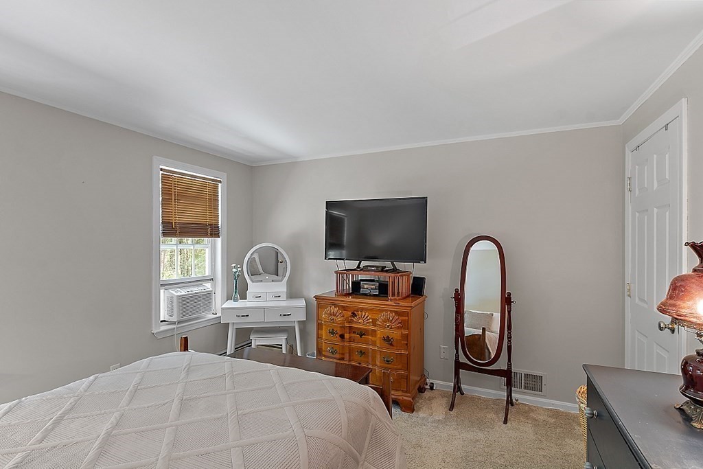 69 Hill Road Groton, MA 01450 - Photo 41 of 42 a bedroom with furniture and a window