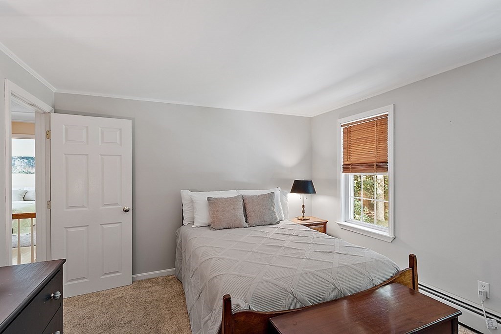 69 Hill Road Groton, MA 01450 - Photo 42 of 42 a bedroom with a bed and a window