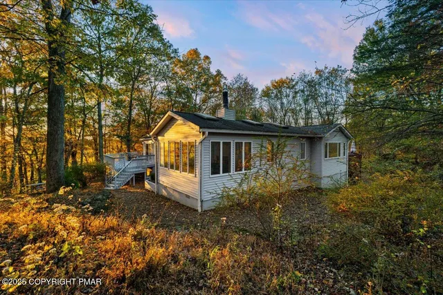 a living room with furniture a flat screen tv and a table