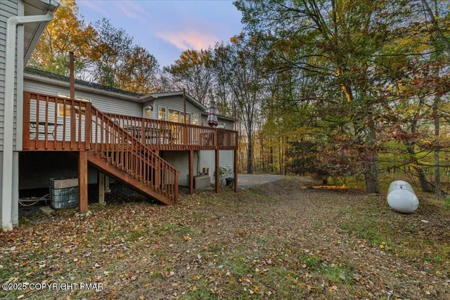a bathroom with a tub a sink and glass door